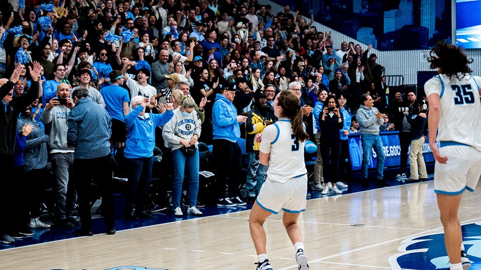 Columbia women's basketball playing a game, cheered on by fans. 