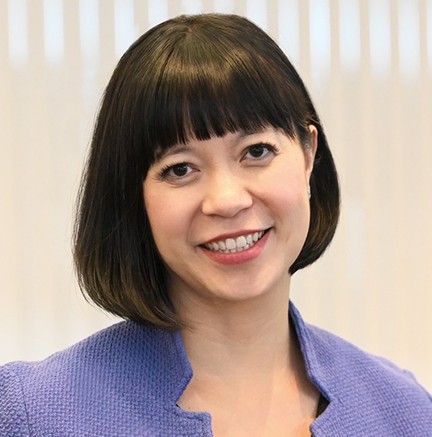 A woman in a purple top. 
