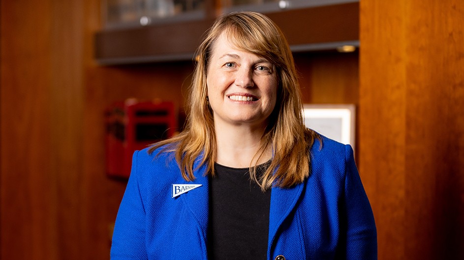 A woman in a blue suit and long, light hair.  