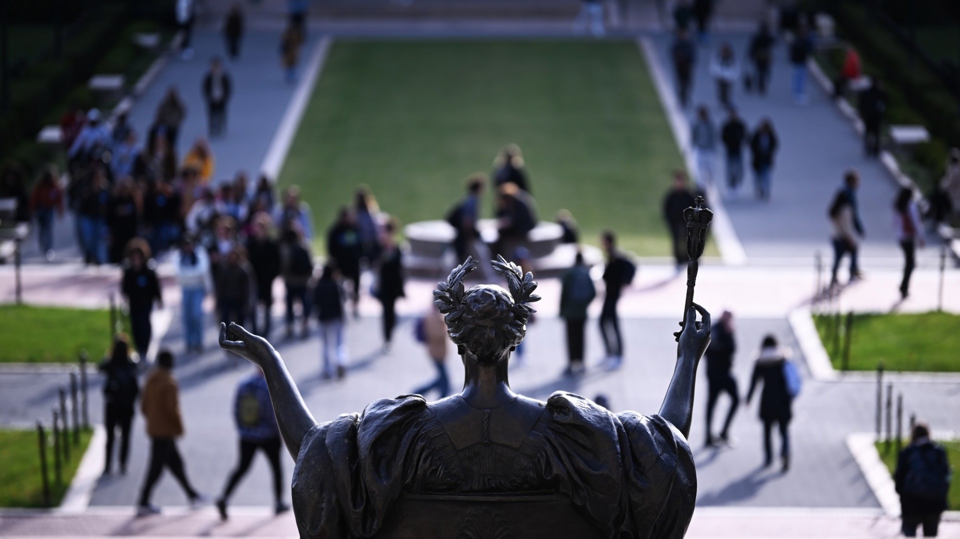 Statue of Alma Mater on Columbia's campus, with students walking in front. 