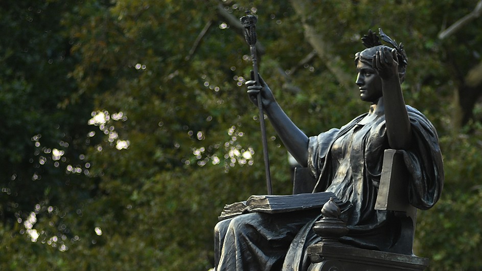Eileen Barroso A bronze statue of Alma Mater, a woman with a laurel wreath in her hair, a scepter, and a classical robe.