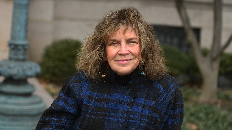 Carol Becker, a woman with medium length, medium-colored hair, in a blue and black plaid jacket. 
