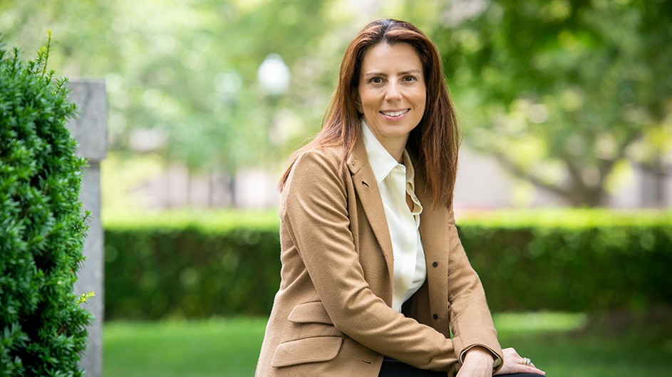 Photo: Shahar Azran. Keren Yarhi-Milo, a woman with long dark hair sitting outside in a tan suit and shirt.