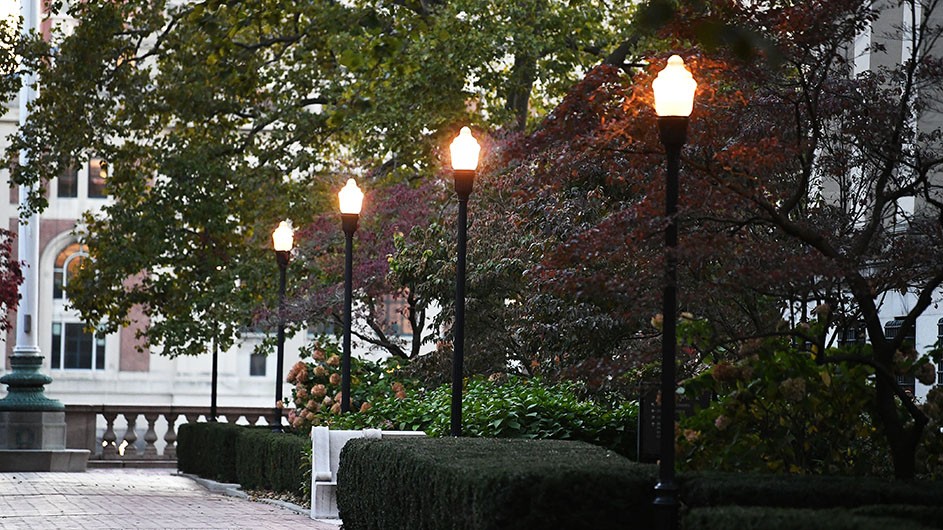 Eileen Barroso Street lamps are illuminated on Columbia's Morningside campus.