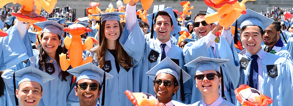 Photo of students in the crowd at Commencement, celebrating with lion balloons.