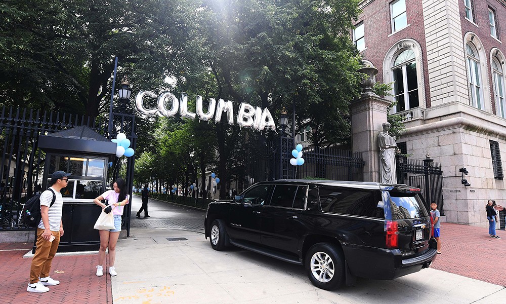 Photo of the Columbia gates during move-in with a black jeep parked out front and "Columbia" spelled in balloons.