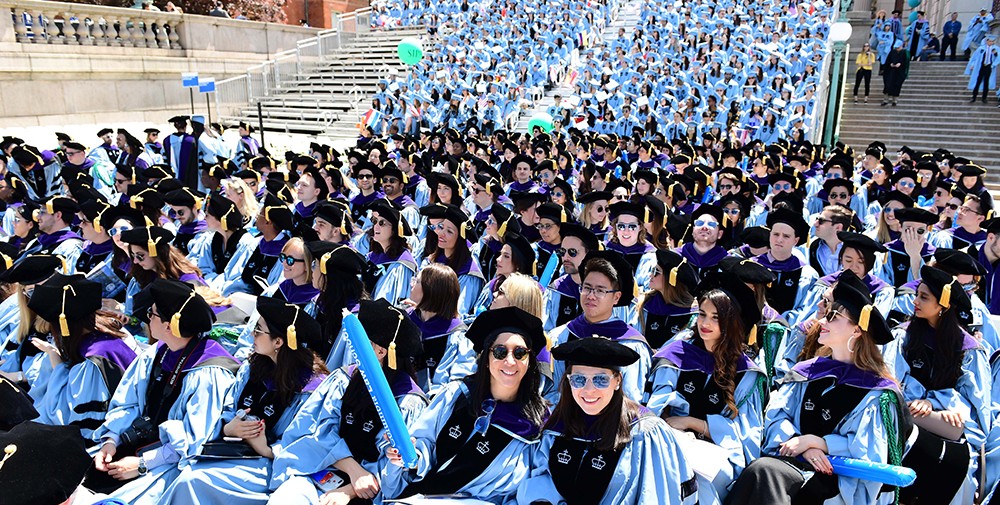 Photo of sitting in the crowd at Commencement, smiling
