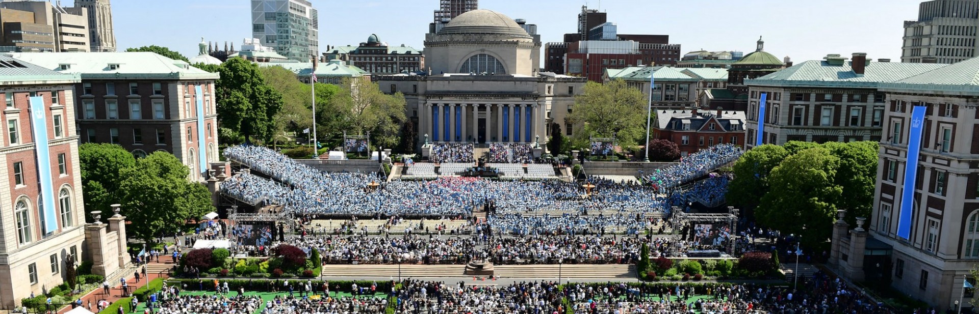 Photo of Low Library and the Columbia steps on the Morningside Campus, filled with people during Commencement