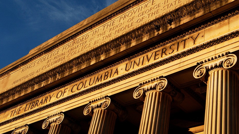 The columns and facade of the classically-designed Low Library on Columbia's Morningside campus, on a clear, blue day