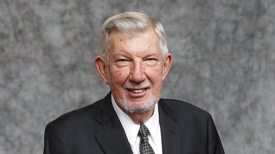 Headshot of Mike Purdy, a man in a dark suit. 