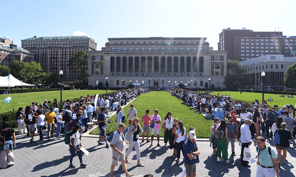 Photo of a crowd gathered in front of Butler Library during new student orientation