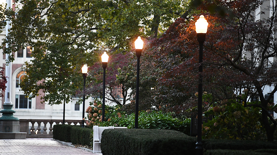 Campus lights against trees and buildings.