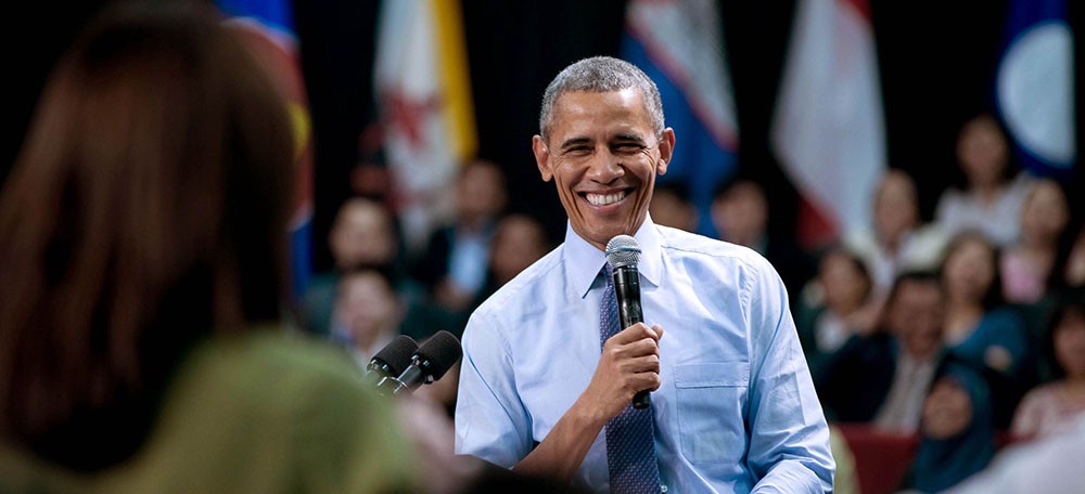 Photo credit Pete Souza Photo of President Obama holding a microphone