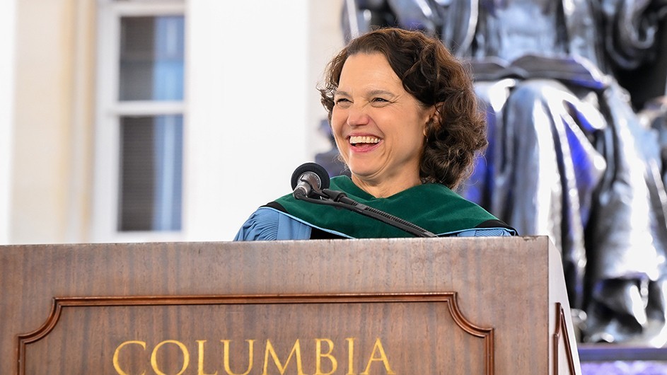 Katrina Armstrong speaking at a podium, with a smile.