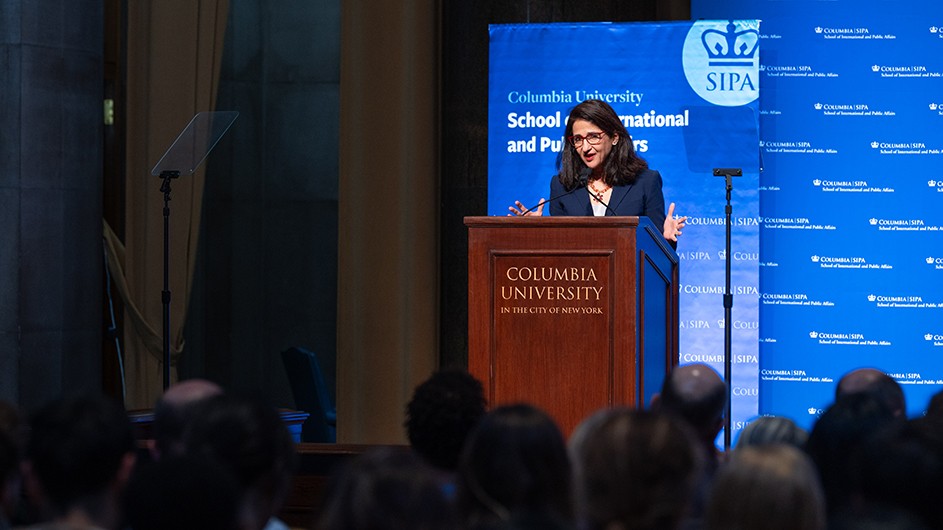 Photo: Nir Arieli. Minouche Shafik standing in front of a podium, speaking.