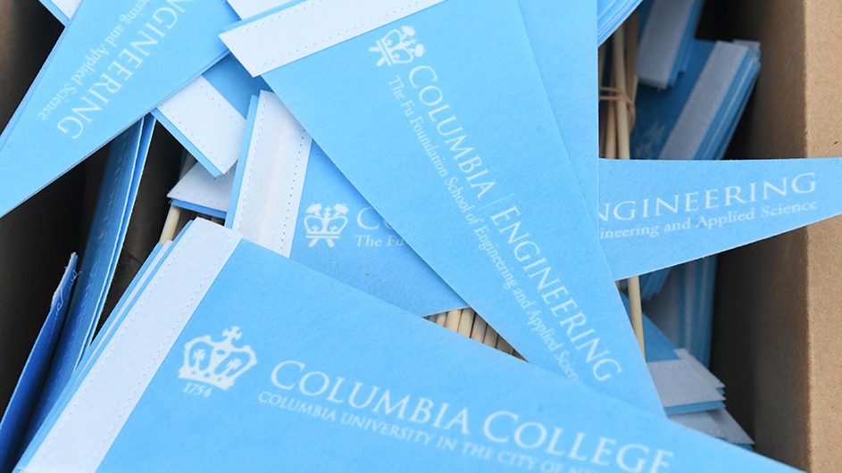 Eileen Baroso Light blue flags that say "Columbia College" and "Columbia Engineering."