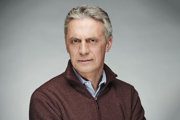 Headshot of Professor Costis Maglaras, a man with short hair in a brown sweater.