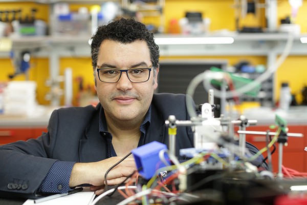 Photo of Dr. Rui Costa, a man with glasses, in his lab. 