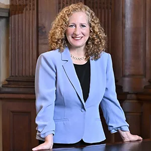 A woman with light hair in a blue suit