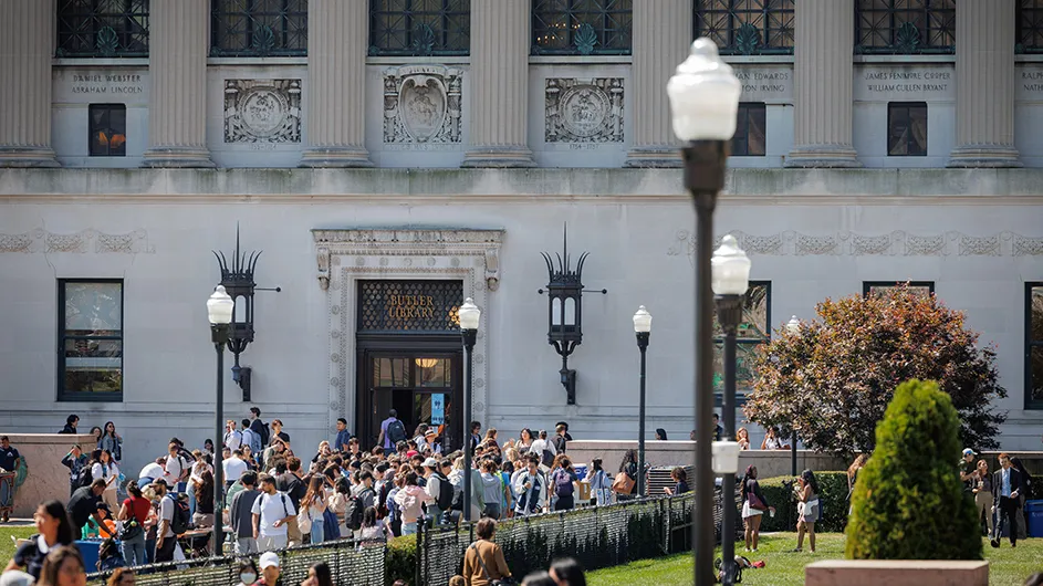 Students walking in front of Butler Library. 