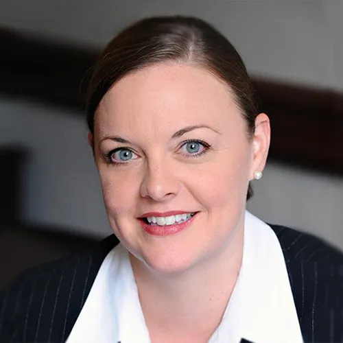 A woman in a dark suit.