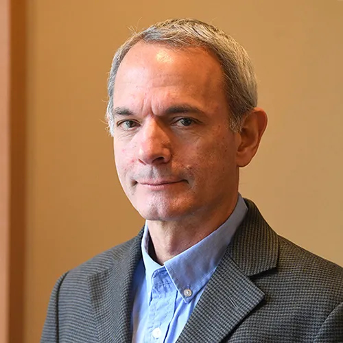 A man in a gray suit and blue shirt. 