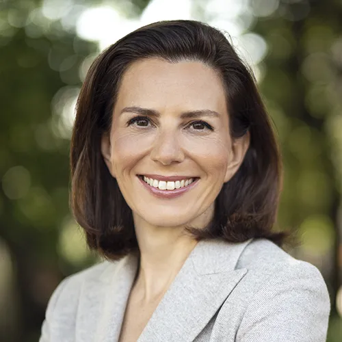 A woman in a light beige top.