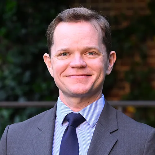 A man in a grey suit and tie. 