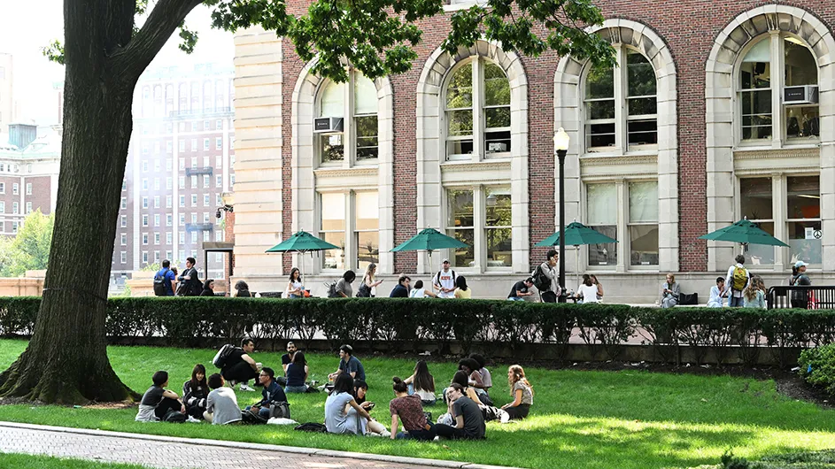 Groups of students gather on Columbia's lawns. 