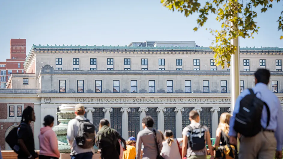 A view of Butler Library with students walking in front of it. 