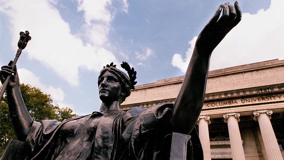 Bronze statue of Alma Mater, a woman sitting down in classical robes with a laurel wreath in her hair, and holding a scepter. 
