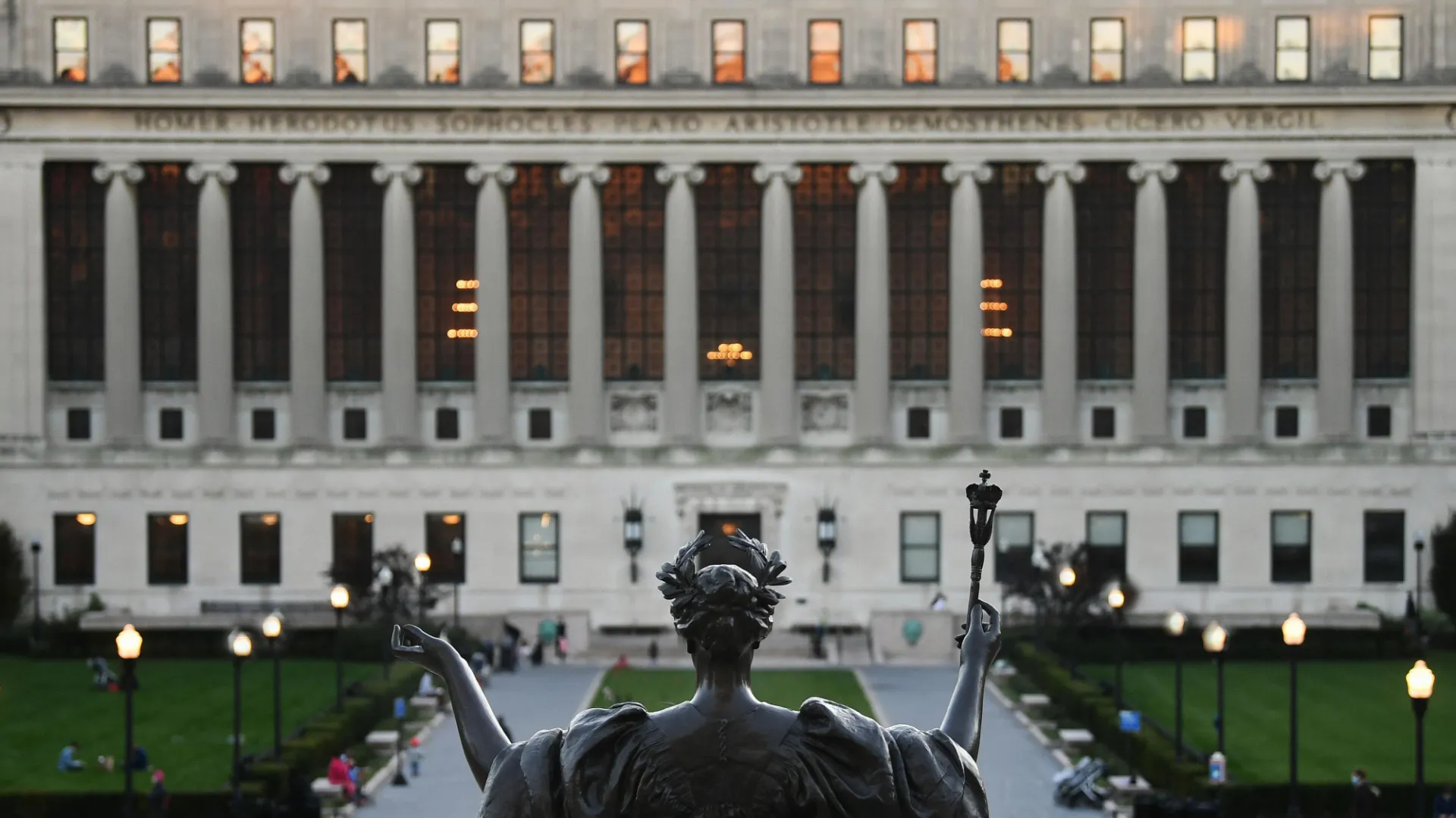 Statue of Alma Mater with a view of Butler Library. 