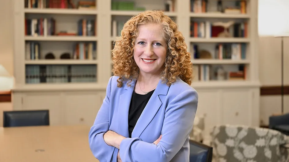 A women with light hair in a blue suit.