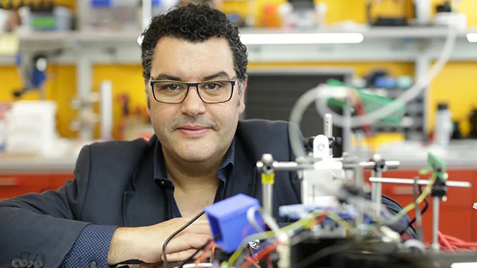 Rui Costa, a man with short dark hair and glasses in a dark suit sitting in a scientific laboratory.