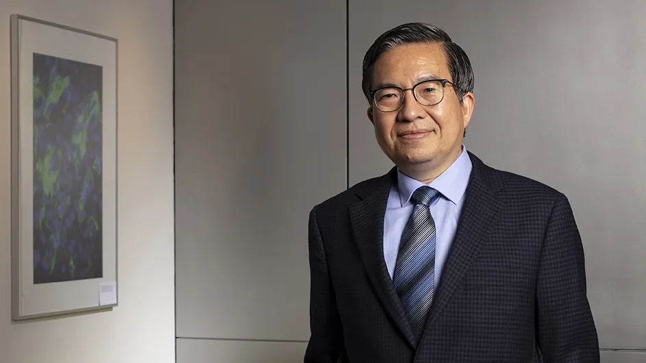 Shih-Fu Chang, a man in a suit and glasses, smiling. 