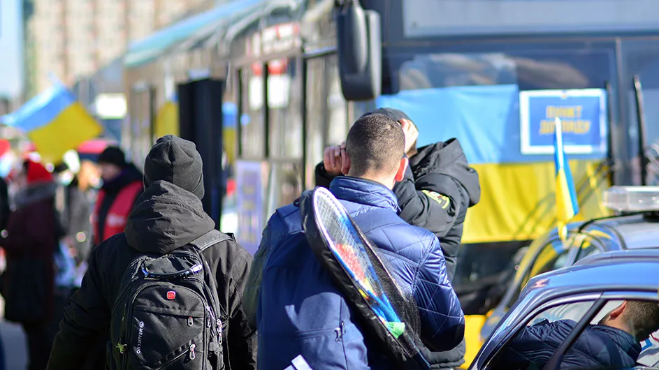 Refugees fleeing and going on buses. 
