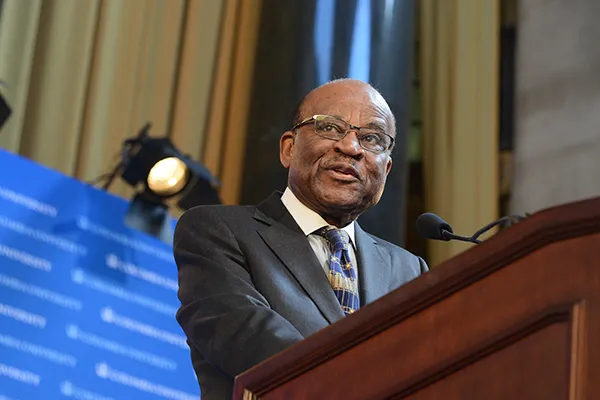 Photo of Dr. Kenneth Forde, a man with glasses in a dark suit.