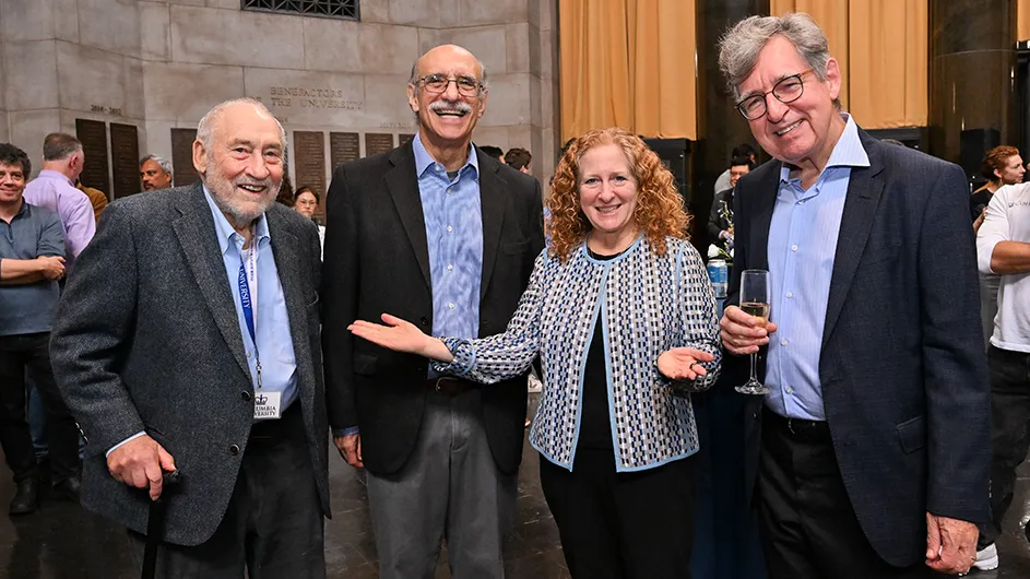 Joseph Stiglitz, Martin Chalfie, Jennifer Mnookin, and Michael Woodford standing around smiling. 

