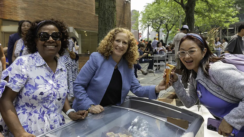 A group of people standing around with ice cream.