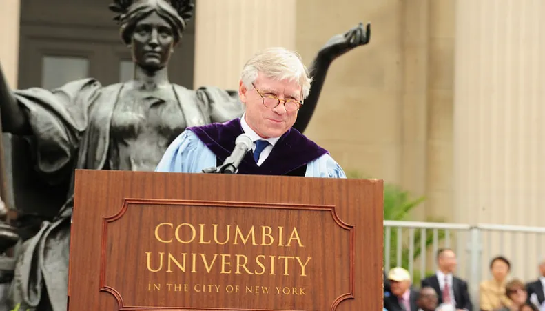 President Lee C. Bollinger at the podium in front of Alma Mater statue at commencement in 2016