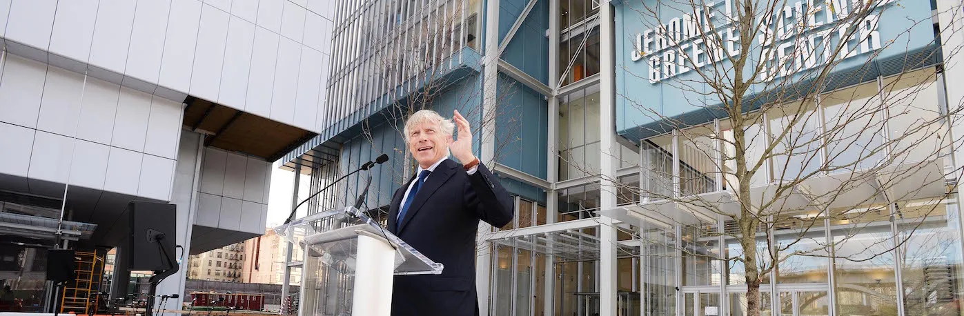 With the Jerome L. Greene Science center building behind him, University President Lee Bollinger gestures to the crowd at the Manhattanville Campus opening. 